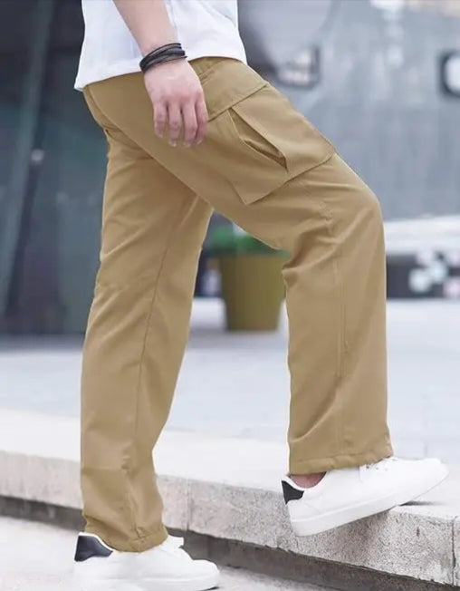 Men wearing tan brown cargo pants with side flap pokets